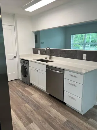 a utility room with a sink dryer and washer