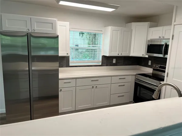 a kitchen with a refrigerator stove and sink