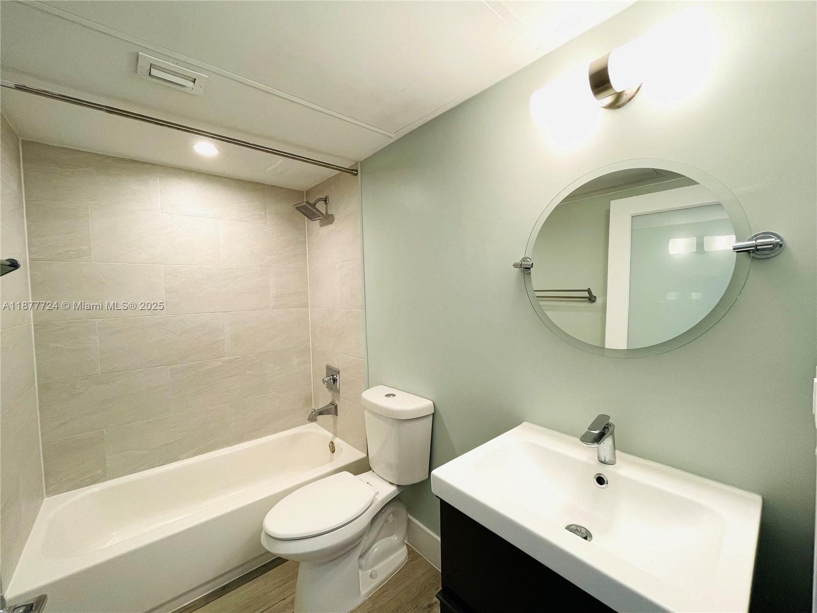 1100 10th Street, Unit 7 Miami Beach, FL 33139 - Photo 4 of 6 a bathroom with a sink a toilet and shower