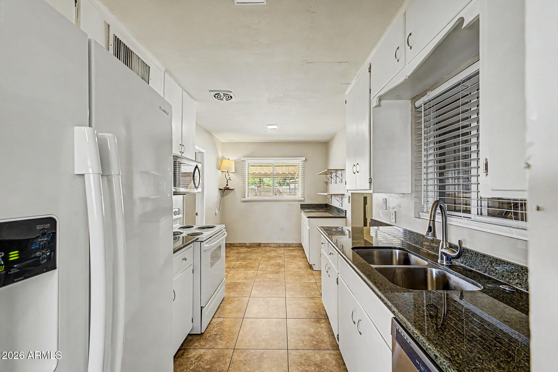 2022 East Monterey Way Phoenix, AZ 85016 - Photo 11 of 29 a kitchen with stainless steel appliances a refrigerator sink and cabinets