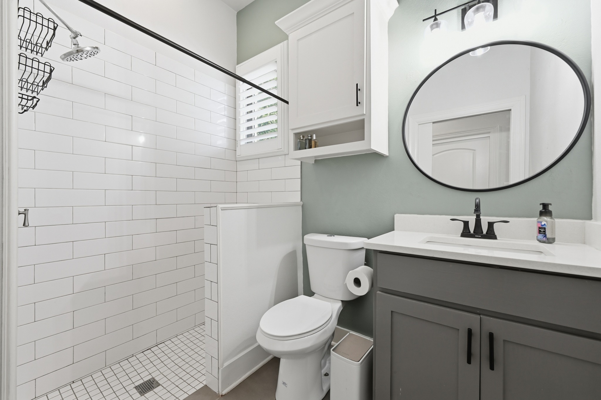 592 Farm To Market 967, Unit B Buda, TX 78610 - Photo 16 of 26 The beautifully appointed primary bath offers a spa-like feel with a spacious walk-in shower, timeless tile finishes, and a modern vanity designed for everyday comfort.
