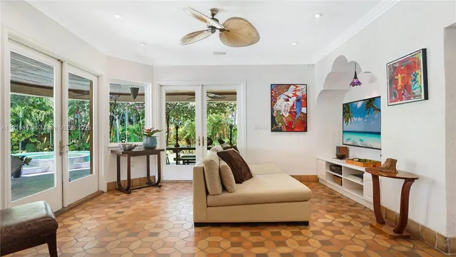 a view of a hallway with wooden floor and windows