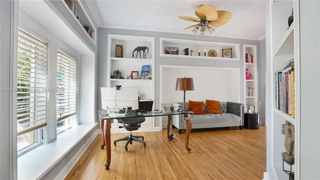 a bedroom with furniture and a large window