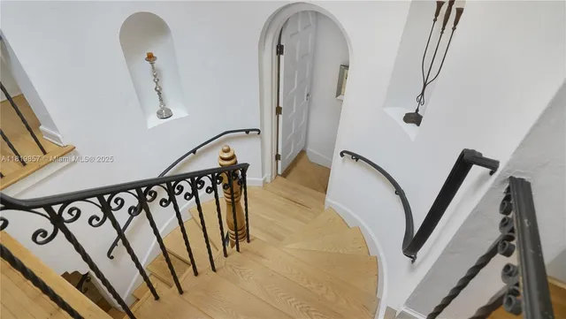 a kitchen with a dining table chairs and white cabinets