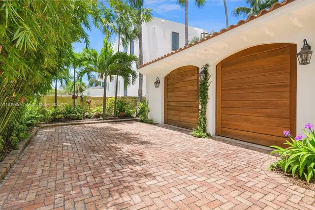 a couple of palm trees in front of yellow house