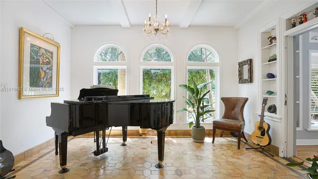 a front view of a house with fountain and large trees