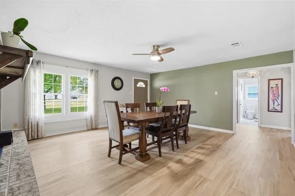 a spacious bedroom with a bed and wooden floor