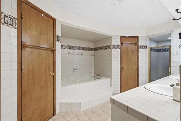 a bathroom with a sink a mirror and a shower