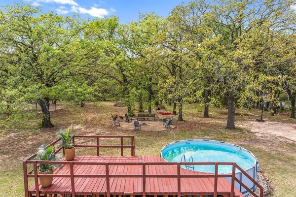 a backyard of a house with table and chairs