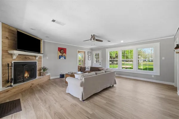 a living room with furniture a fireplace and a flat screen tv