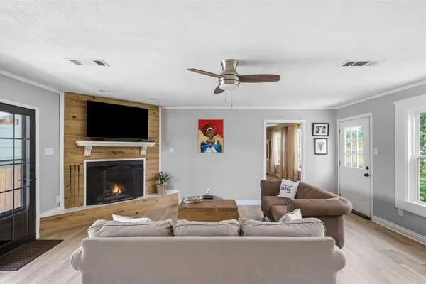 a living room with furniture and large windows