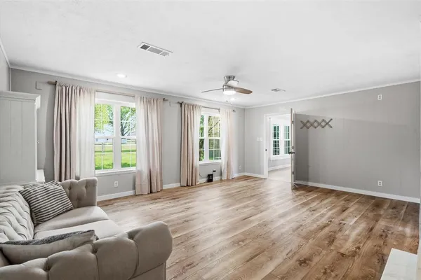 a view of a livingroom with furniture and chandelier fan