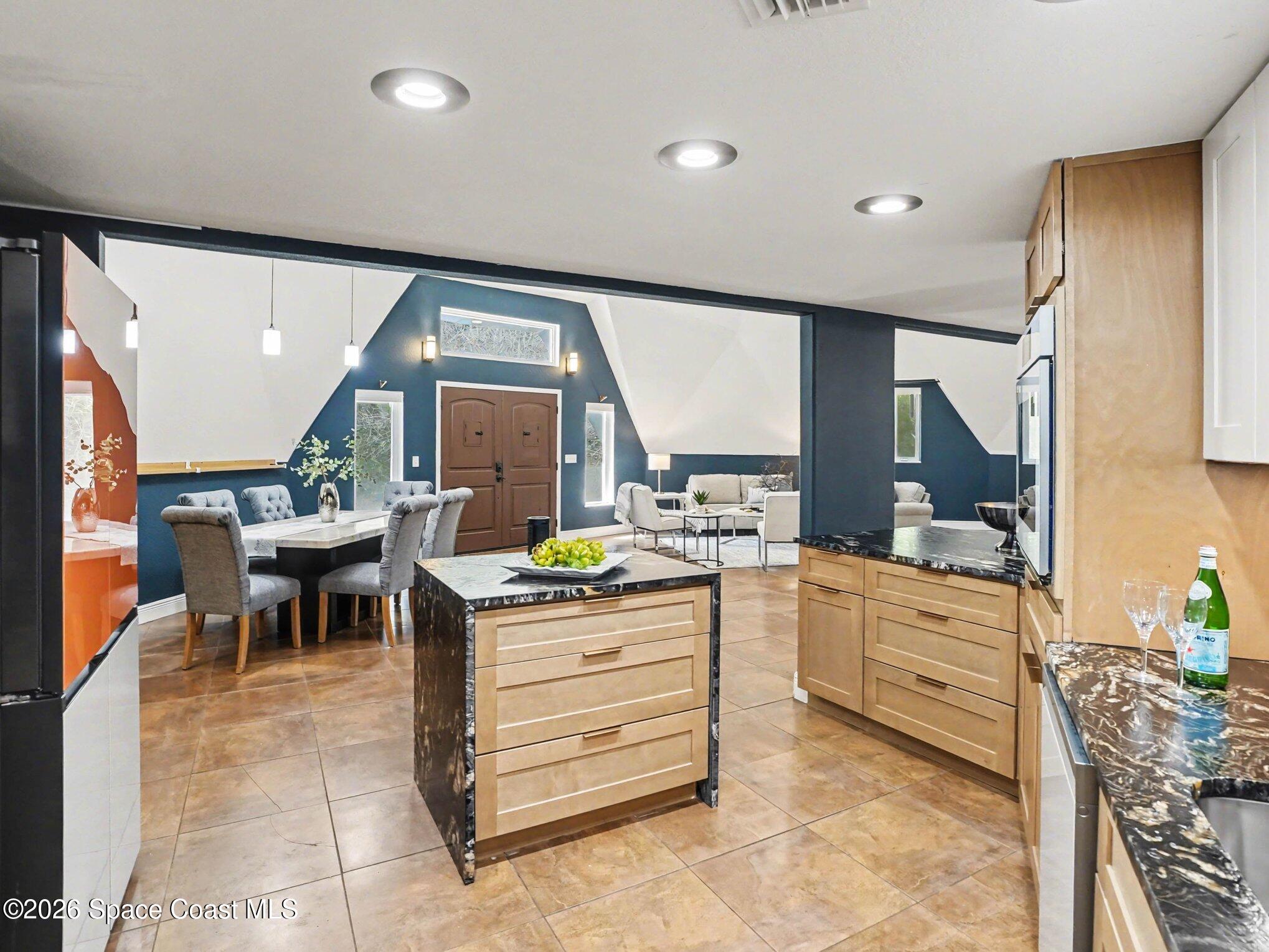 4045 Jake Avenue Cocoa, FL 32926 - Photo 5 of 35 a kitchen with kitchen island granite countertop a sink and counter space