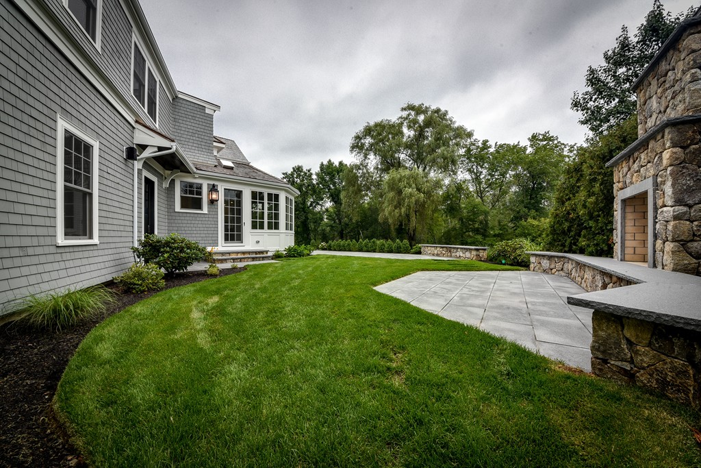 19 Falmouth Road Wellesley, MA 02481 - Photo 15 of 29 a view of a house with a backyard and a garden