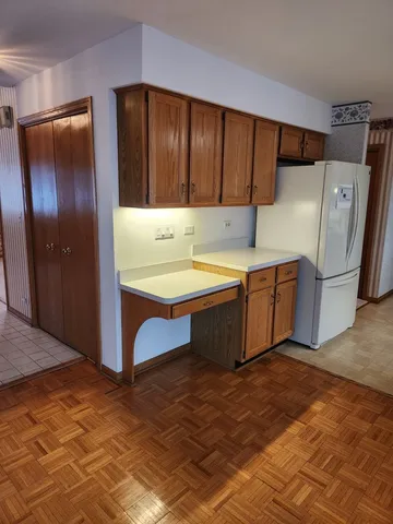 a kitchen with a refrigerator and window