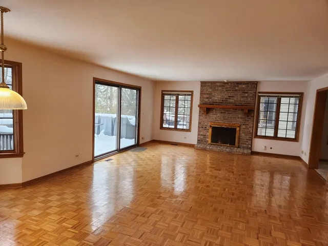 a living room with a fireplace and a exposed radiator