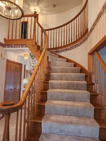 a view of entryway with wooden floor and a front door
