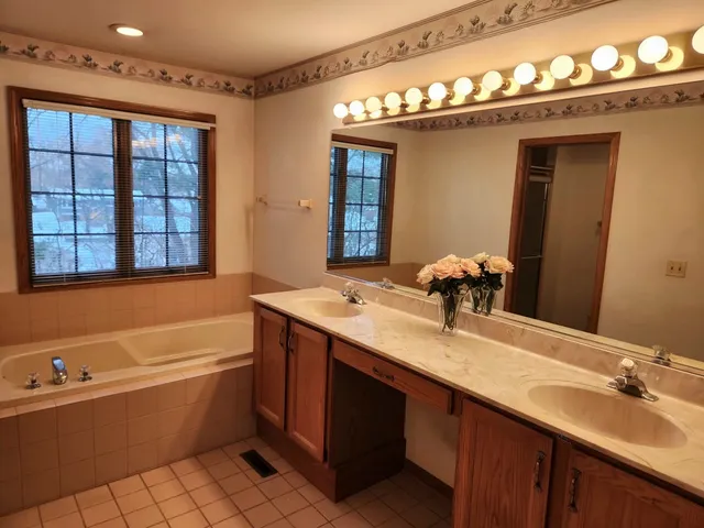 a bathroom with a granite countertop shower and toilet