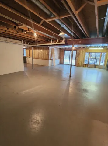 a view of empty room with wooden walls