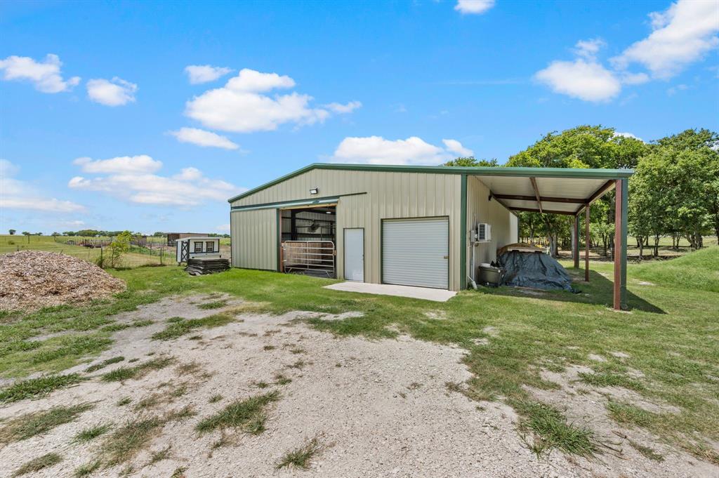 1216 W Road Waxahachie, TX 75165 - Photo 31 of 40 a view of a house with backyard and a tree