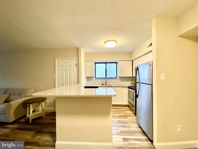 a kitchen with stainless steel appliances a refrigerator and a stove