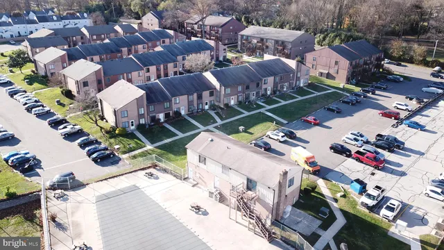 an aerial view of multiple houses with yard