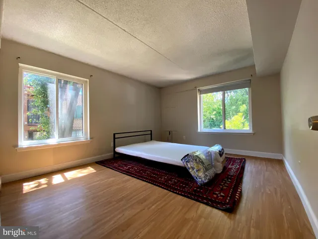 a bedroom with bed and window