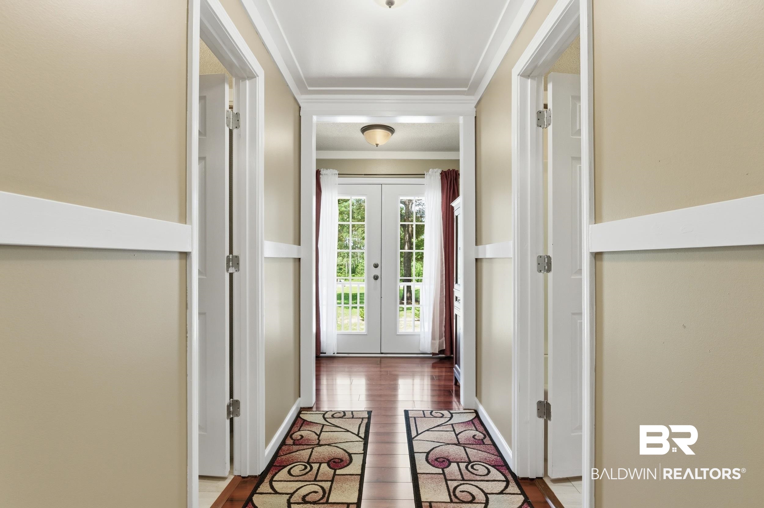 51620 Robert White Road Bay Minette, AL 36507 - Photo 51 of 81 Hallway with wood-finish flooring, light beige walls, and white trim details