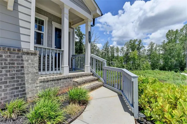 a view of a house with brick walls and wooden fence