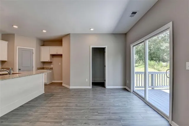 a kitchen with stainless steel appliances granite countertop a refrigerator and a stove top oven