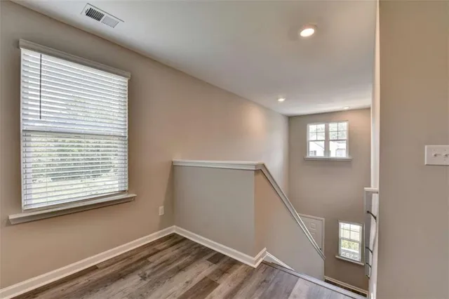 a view of entryway and hall with wooden floor