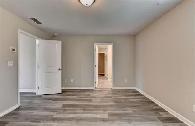 a view of an empty room and wooden floor