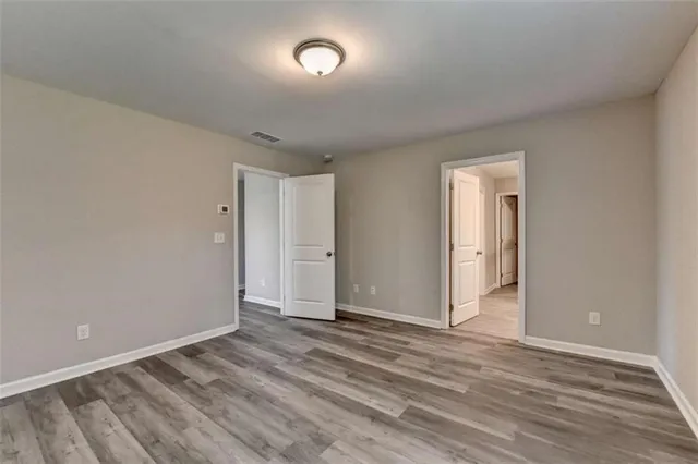 a view of an empty room and wooden floor