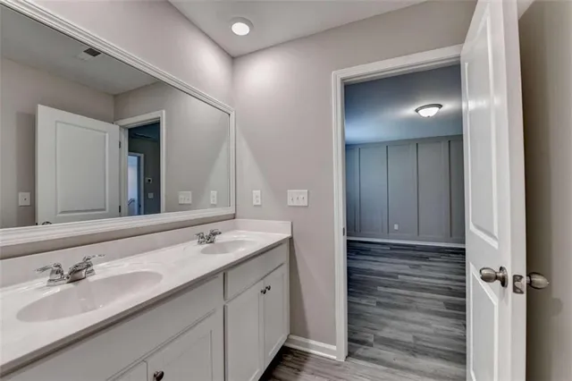 a bathroom with a double vanity sink and a mirror