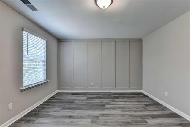 a view of room with window and hardwood floor