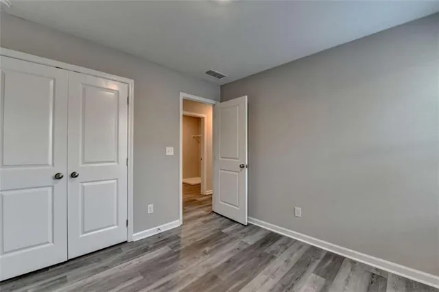 a view of an empty room and wooden floor