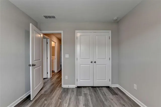 a view of hallway with wooden floor