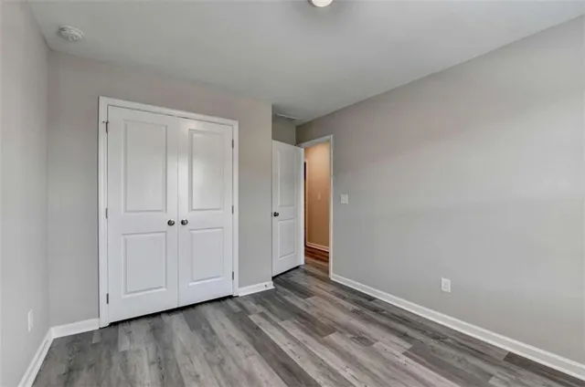 a view of an empty room and wooden floor