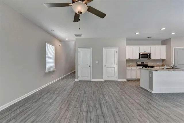 a view of kitchen with refrigerator microwave and stove