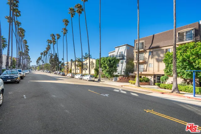 a view of a street with cars on city street