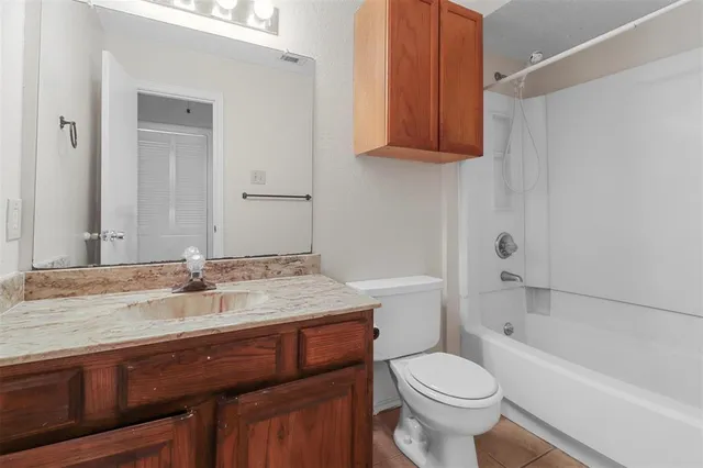 a bathroom with a sink a toilet and bathtub