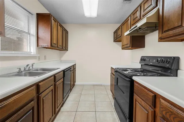 a kitchen with stainless steel appliances granite countertop a stove and a sink