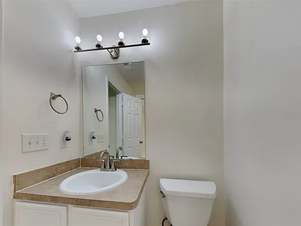 an empty room with chandelier fan
