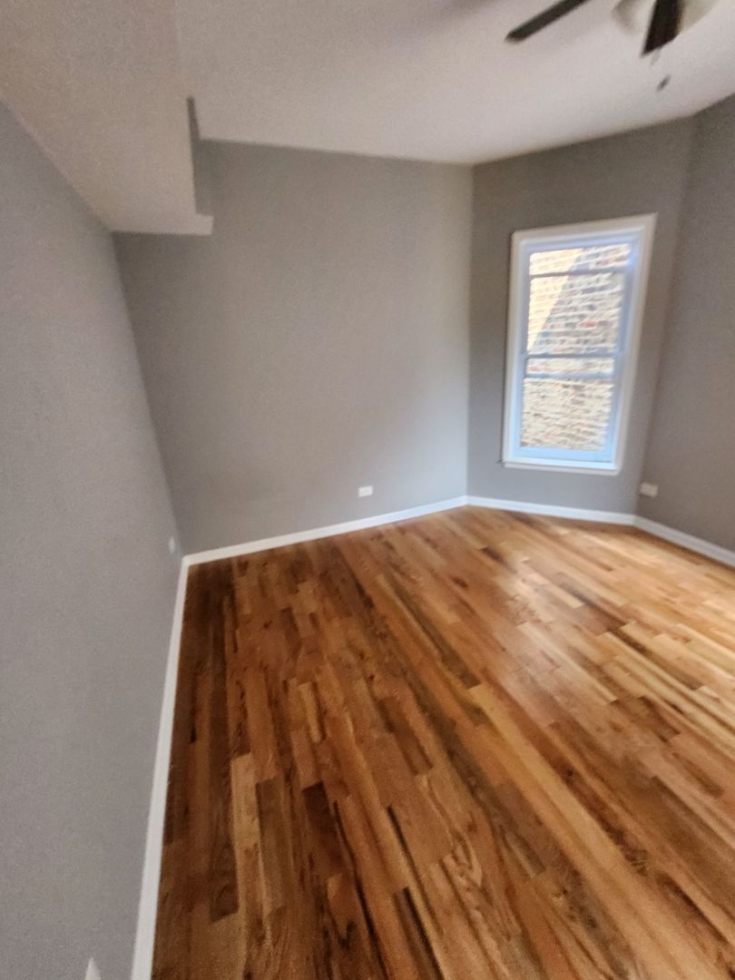 Undisclosed Address Chicago, IL 60624 - Photo 17 of 27 a view of room with window and hardwood floor