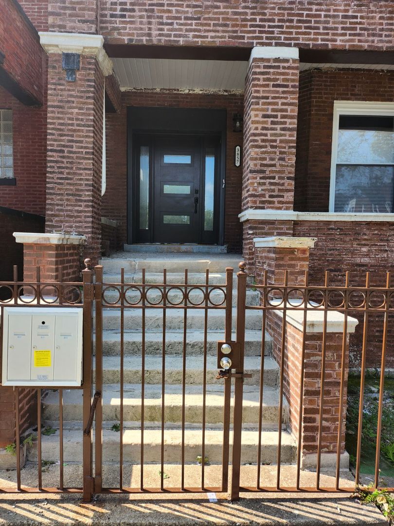 Undisclosed Address Chicago, IL 60624 - Photo 2 of 27 a view of an entrance to house with yard