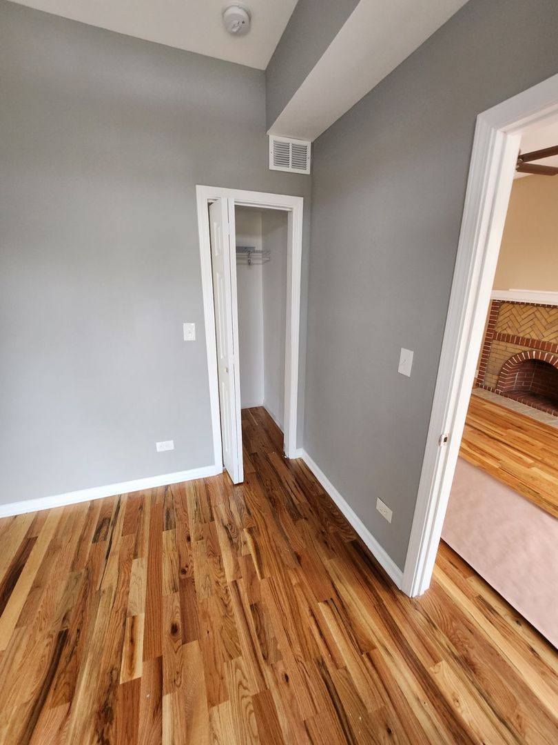 Undisclosed Address Chicago, IL 60624 - Photo 21 of 27 a view of a room with wooden floor and staircase