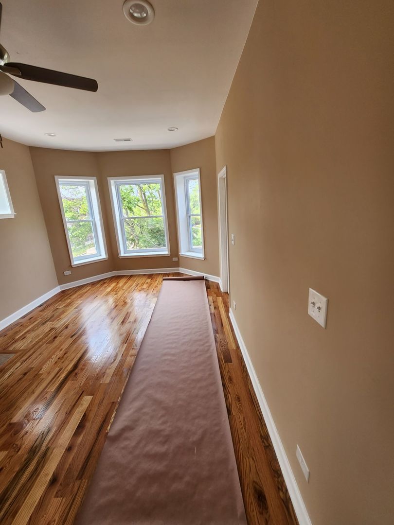 Undisclosed Address Chicago, IL 60624 - Photo 24 of 27 wooden floor in an empty room with a window