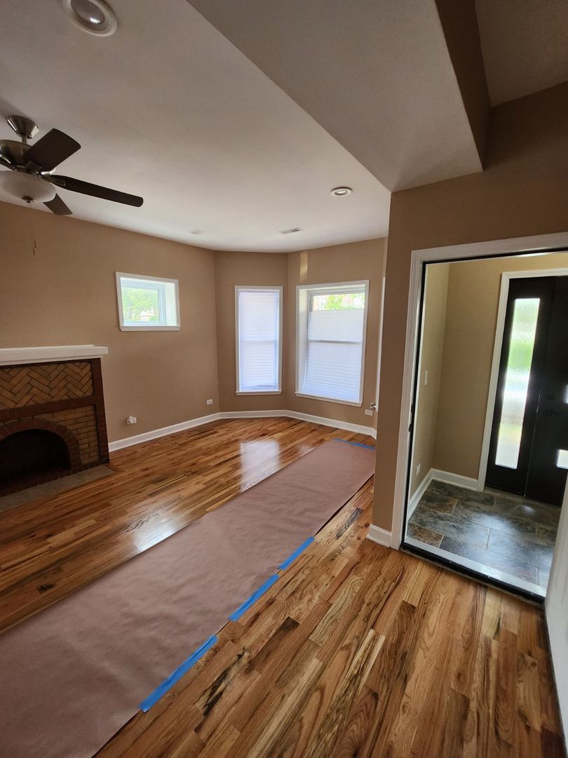 Undisclosed Address Chicago, IL 60624 - Photo 3 of 27 a view of a room with wooden floor and window