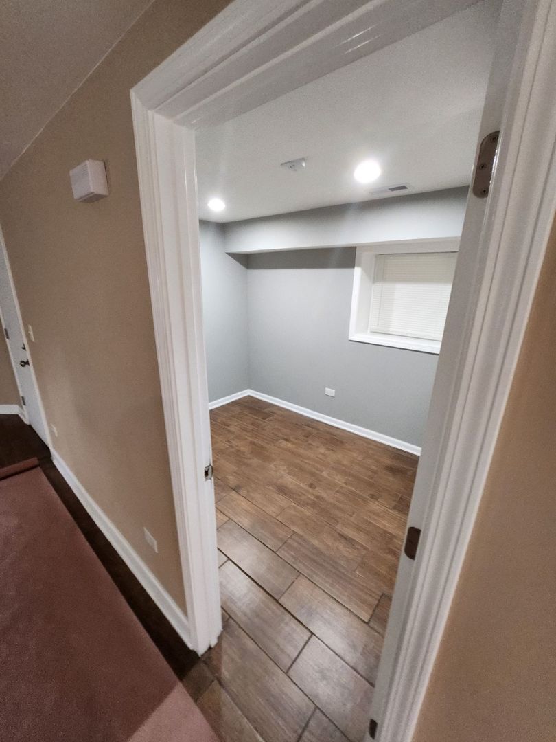 Undisclosed Address Chicago, IL 60624 - Photo 4 of 27 wooden floor in an empty room with a window