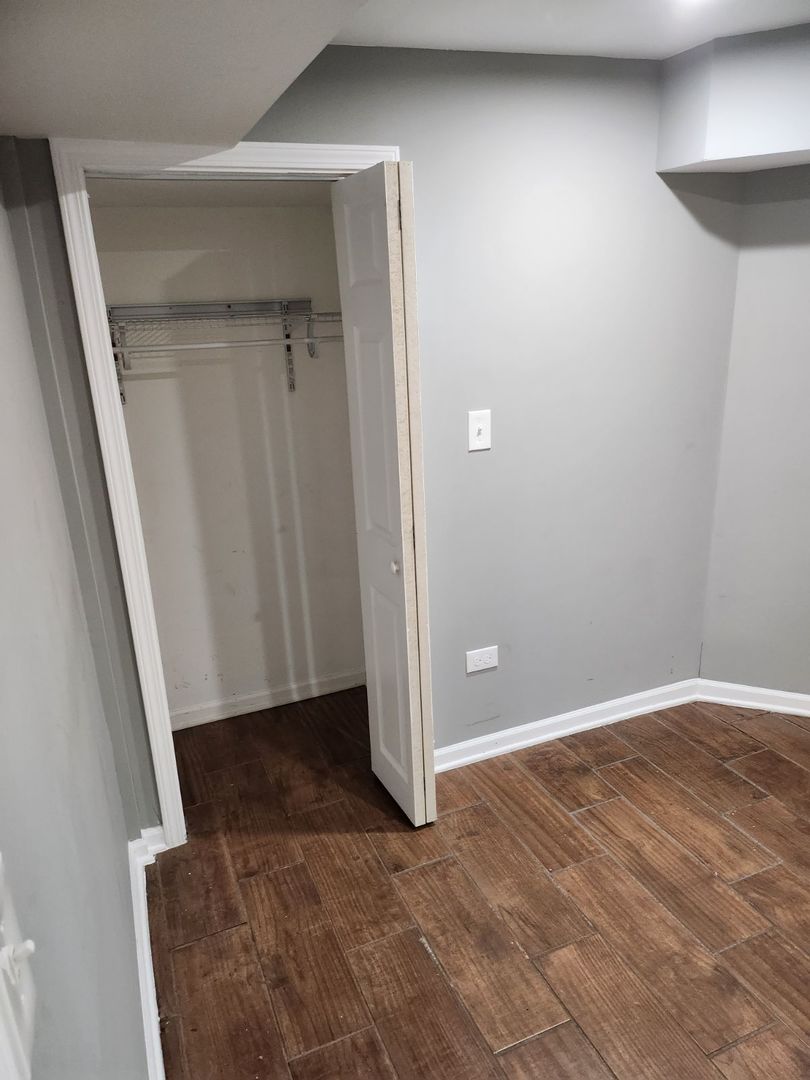 Undisclosed Address Chicago, IL 60624 - Photo 6 of 27 an empty room with a wooden door